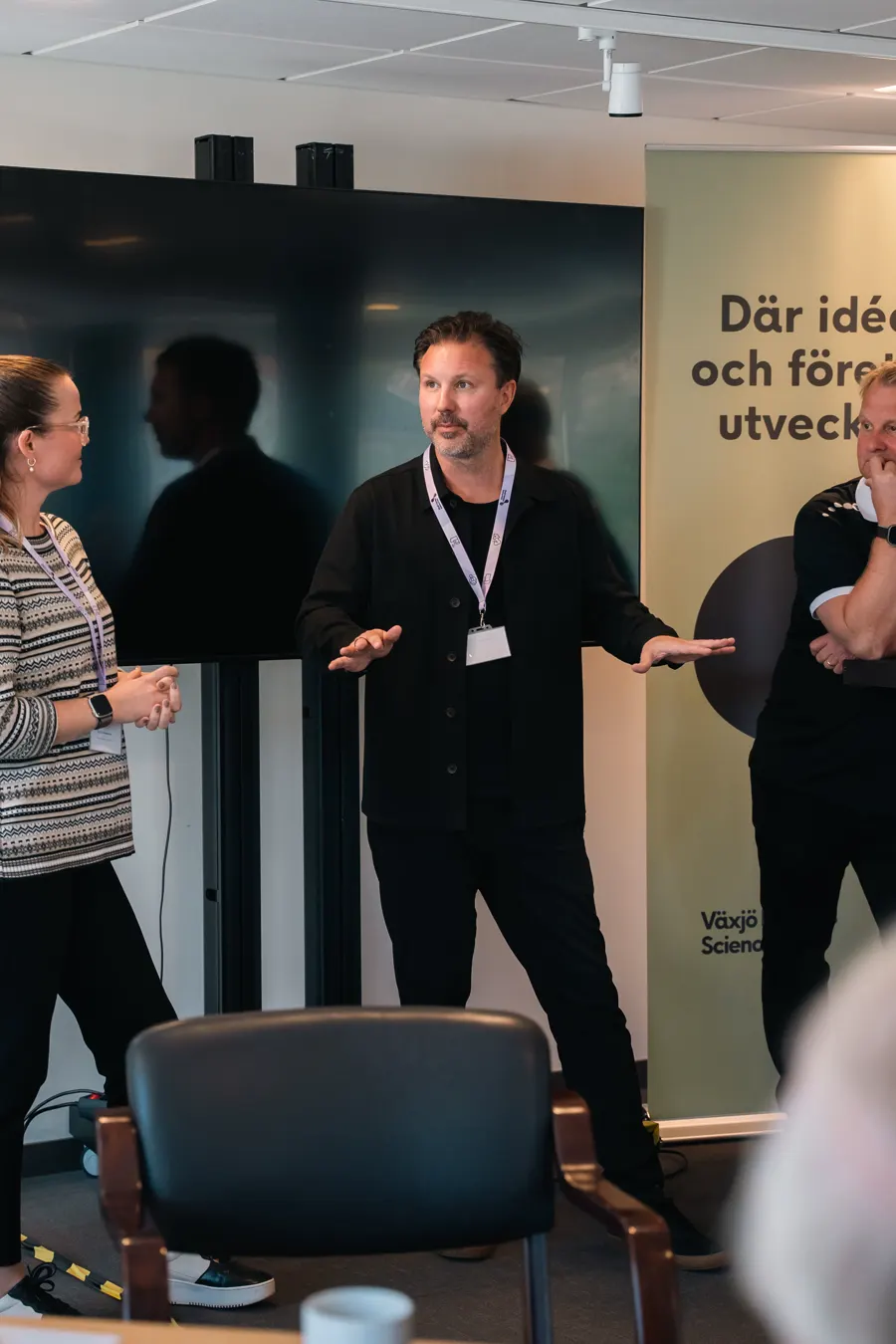 Mathias Karlsson förklarar något med händerna, stående framför en grupp